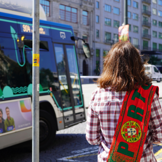A Portugal supporter near an STCP bus.